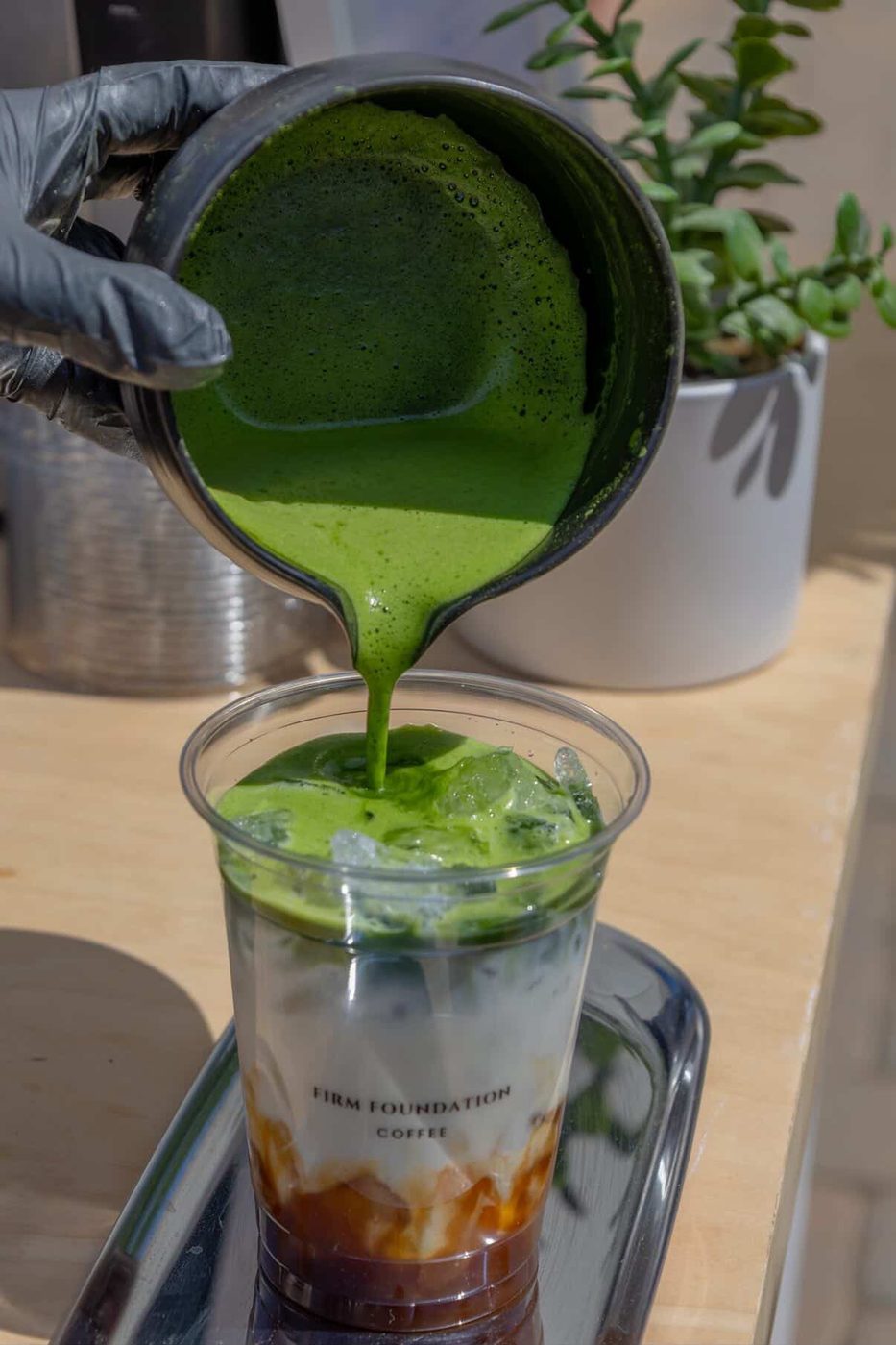 Matcha being poured over ice at the Firm Foundation Coffee cart